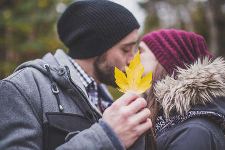 Couple in the autumn park having funの写真素材