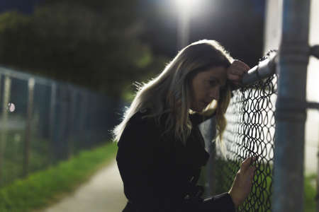 portrait of young sad woman at night