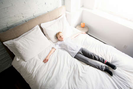 A child portrait in white bed like tired