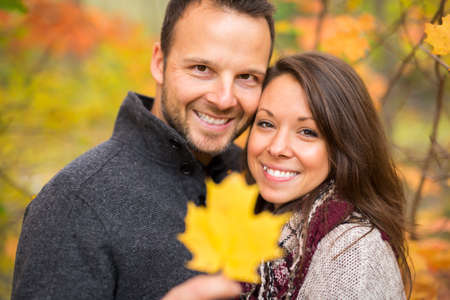 Young couple in love in a park on a autumn day