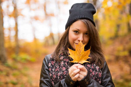 Portrait of cheerful young woman in autumn seasonの写真素材