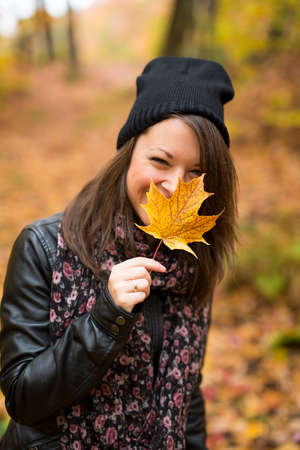 Portrait of cheerful young woman in autumn season
