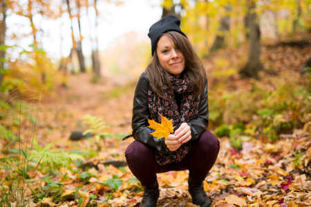 Portrait of cheerful young woman in autumn season