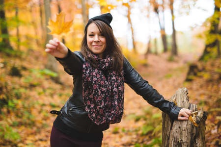 Portrait of cheerful young woman in autumn season