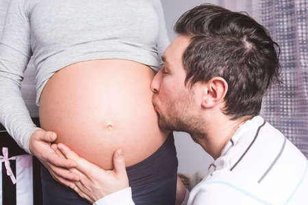 Pregnant Mother and her husband on baby room