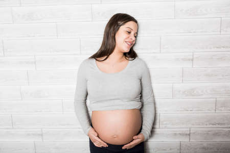 Pregnant woman in baby room
