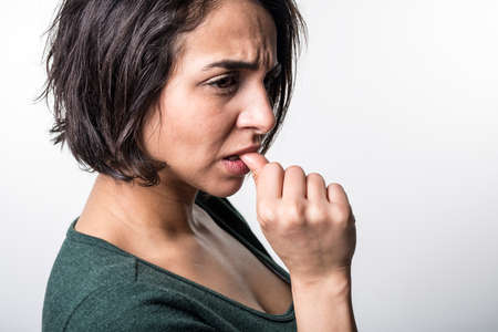 Portrait of beautiful woman, she bites her fingersの写真素材