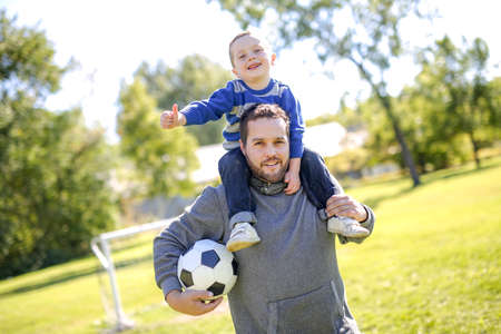 Father and Son Playing Ball in The Parkの写真素材