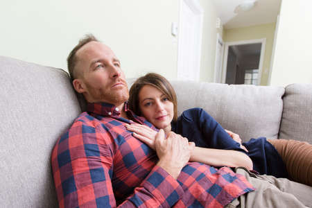 Young couple lying on sofa