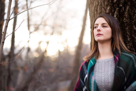 Woman with long hair in forest in autumn seasonの写真素材