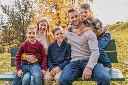 Family Group having fun Outdoors In Autumn Landscape