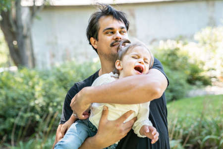 young father with little daughter outdoors, the child have a terrible two crisisの写真素材