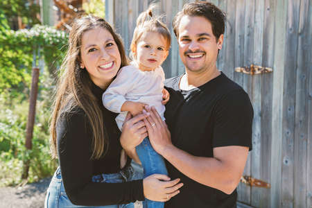 Young family with cute two years old child outside