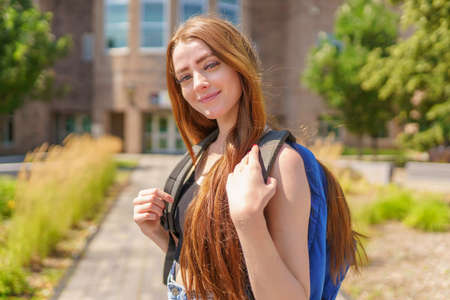 Portrait of beautiful student teenager schoolchild go to school with backpack.の写真素材