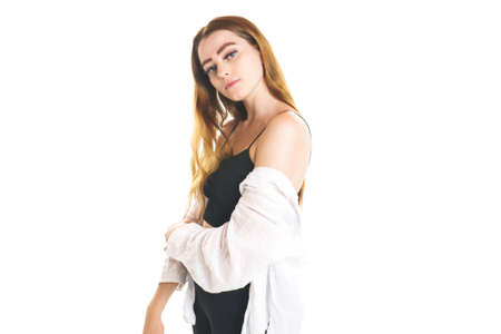 Portrait of young beautiful and cheerful girl looking at camera over white background.