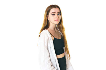 Portrait of young beautiful and cheerful girl looking at camera over white background.の写真素材
