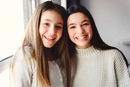 Two Teens spending time on bedroom at homeの写真素材