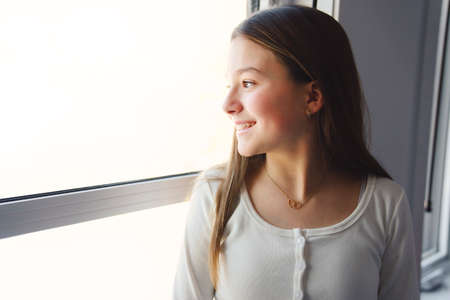 Teen spending time on bedroom at home