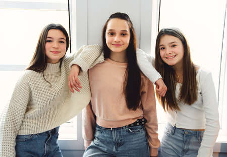 Three Teens spending time on bedroom at homeの写真素材