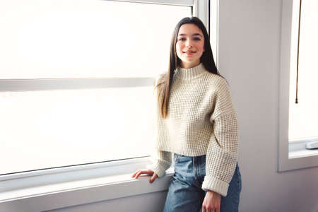 Teen spending time on bedroom at home