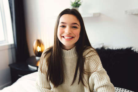 Teen spending time relaxing on bedroom at homeの写真素材