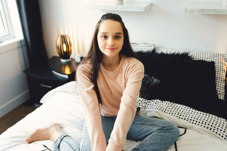 Teen spending time relaxing on bedroom at homeの写真素材