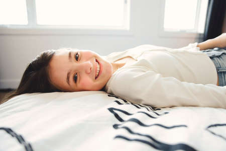 Teen spending time relaxing on bedroom at homeの写真素材