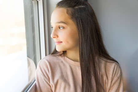 Teen spending time on bedroom at homeの写真素材