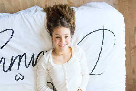 Teen spending time relaxing on bedroom at home