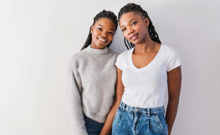 mother and her teenage daughter on whiteの写真素材