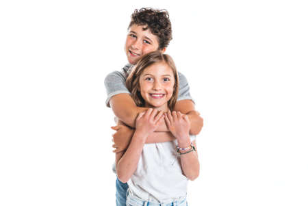 Portrait of cute girl and boy on studio white backgroundの写真素材