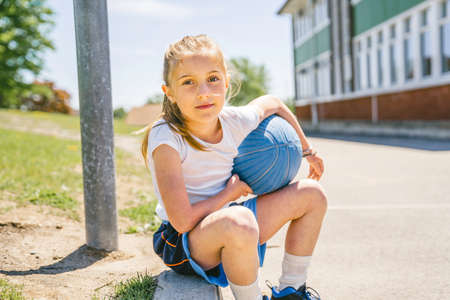 Girl holding a basketball at the parkの写真素材