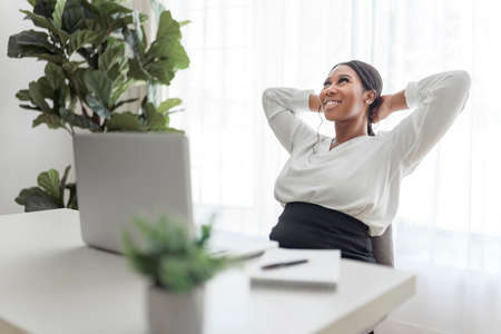 young Success, African American businesswoman working at laptop at home officeの写真素材