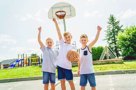 Young Boys brother Playing Basketball on the summer time