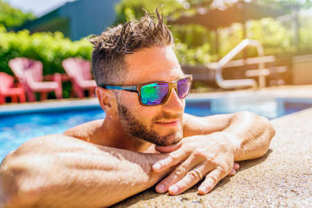 Nice man relaxing on the swimming poolの写真素材