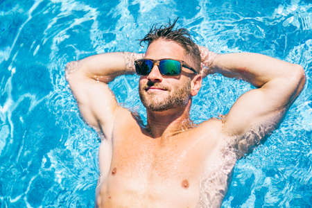 Nice man relaxing on the swimming pool