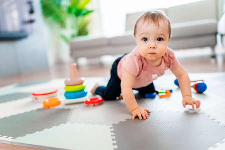 Cute toddler girl playing in the living room