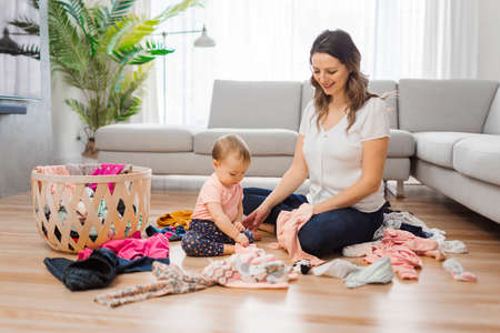 woman playing with her baby in the living roomの写真素材