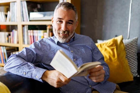 mature Man Reading a Book seat look like relax