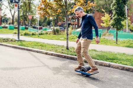 man with electric transporter riding in the street
