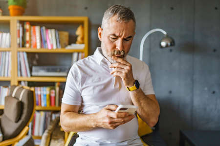 man at modern loft home using mobile phone