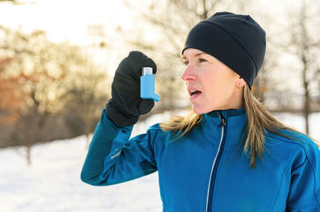 mature woman running at winter in park have some breathing diffi