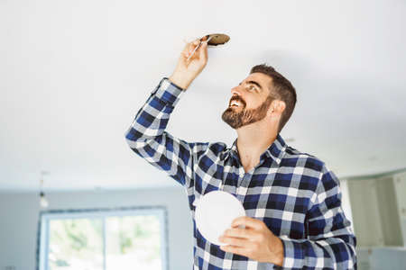 Portrait of an electrician happy worker at work