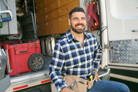 Portrait of an electrician happy worker at work