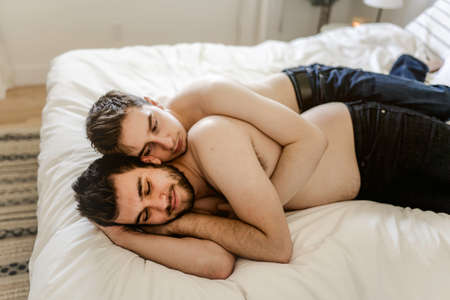 homosexual couple under a bed at homeの写真素材