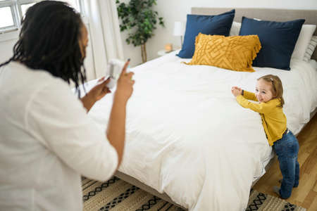 babysitter black woman play with little child girl