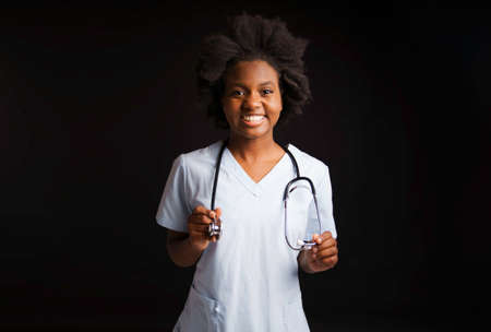 portrait of afro american female nurse on black backgroundの写真素材