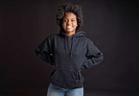 portrait of a young teen with black hoodies studio shot with black background