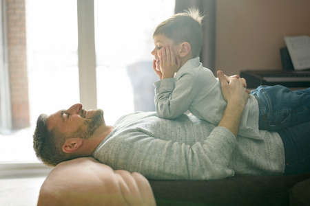 Father or Godfather having fun relaxing on the living room At Home