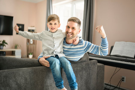 Father or Godfather having fun on the living room At Home with strong fistの写真素材